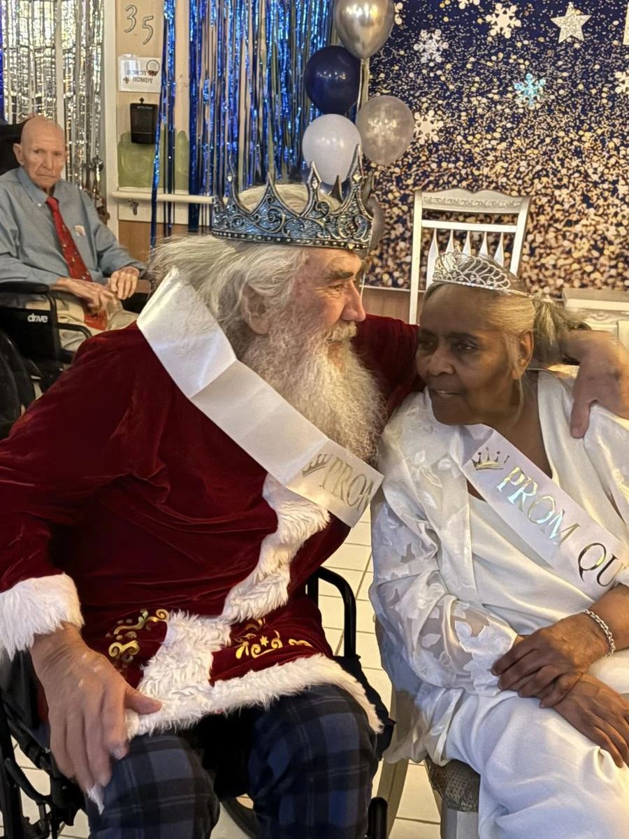 The prom king and queen, two residents in crowns and sashes, at a past Front Porch Senior Prom