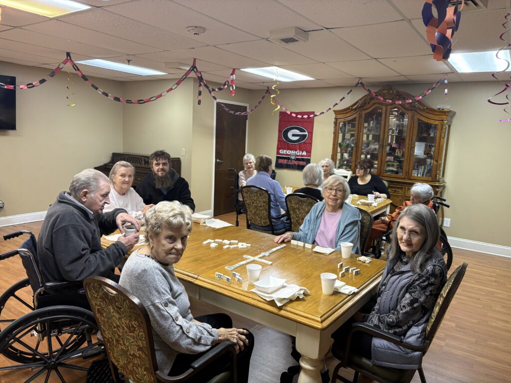 Residents and family sharing a meal around a table at Front Porch