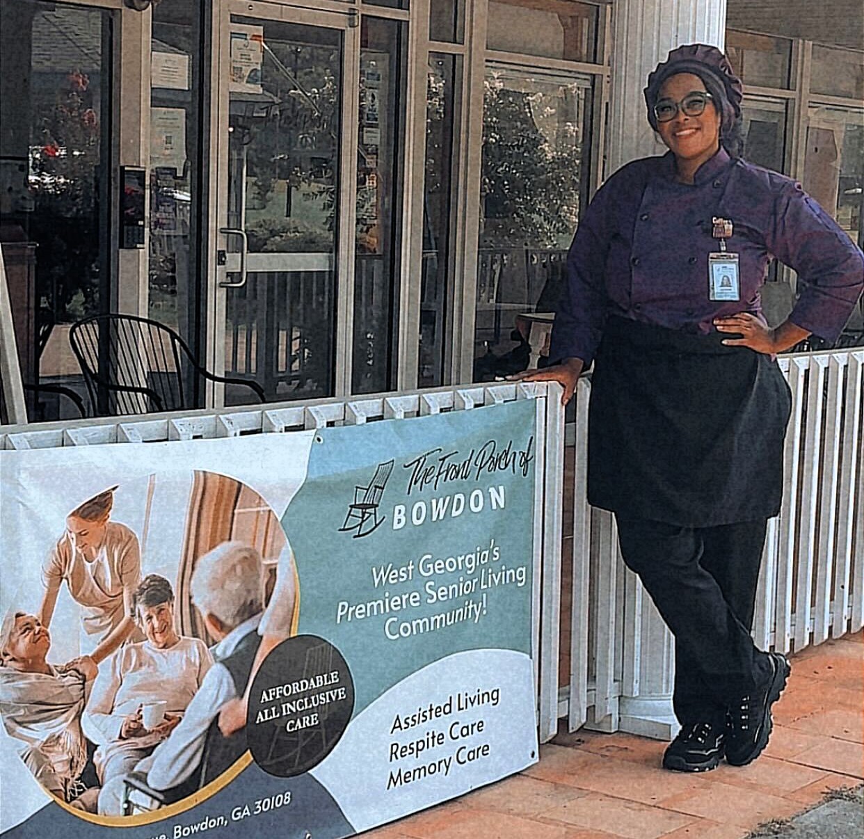 Chef Ja'Nicole, Dietary Manager at Front Porch of Bowdon, standing by the front entrance in her chef coat
